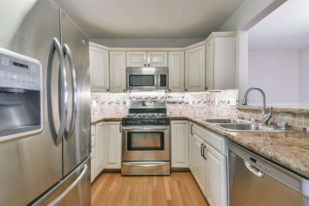 Updated kitchen with granite counter tops, under cabinet lighting, and stainless steel appliances.